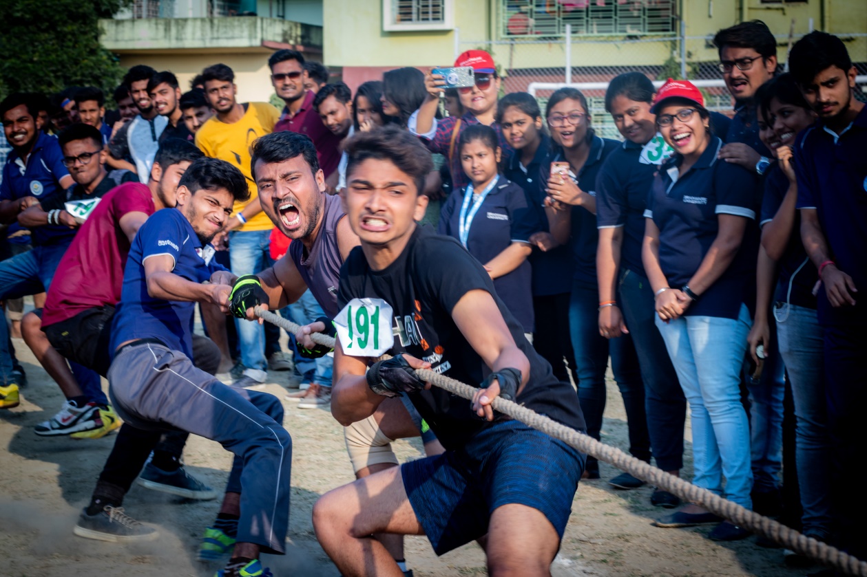 Brainware students participating in tug of war on sports day